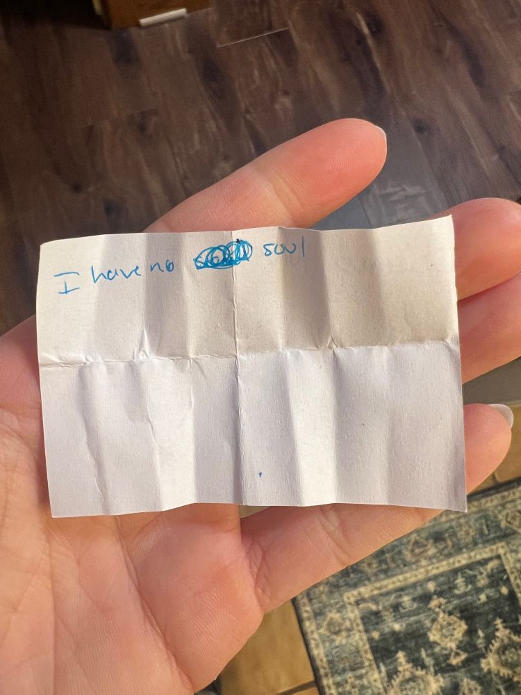 White paper with note written in blue ink that states I have no soul