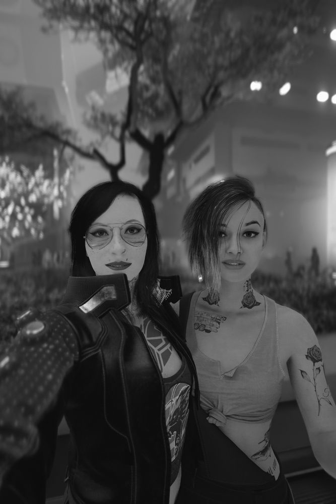 A black and white selfie style screenshot of V and Judie from the game Cyberpunk 2077