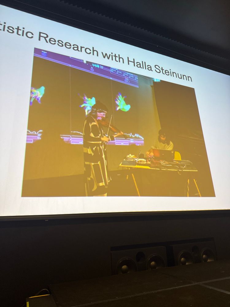 Presenter slide of a violinist and computer musician 