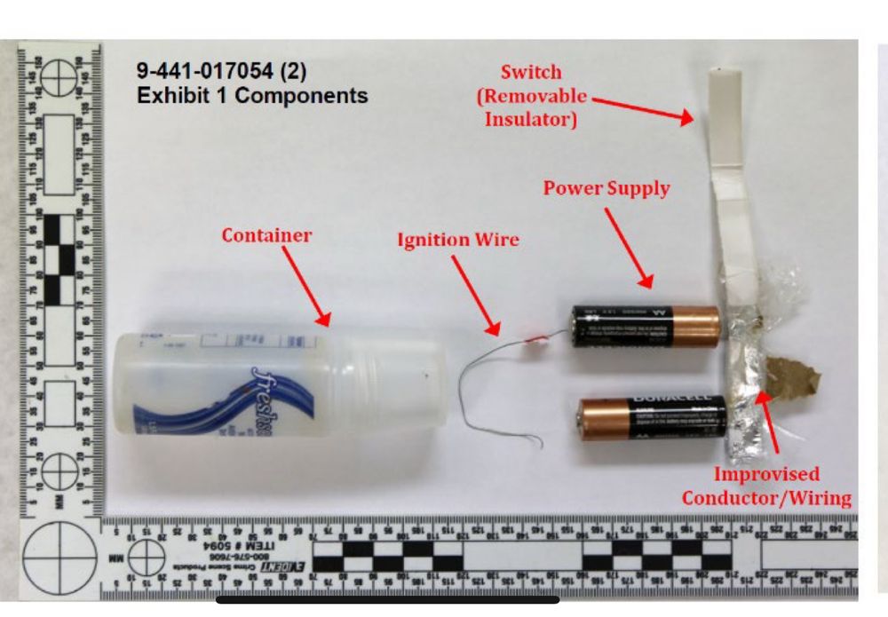 Evidence photo of the bomb showing a container of hand sanitizer, ignition wire, two AA batteries, and the paper/foil switch/trigger.