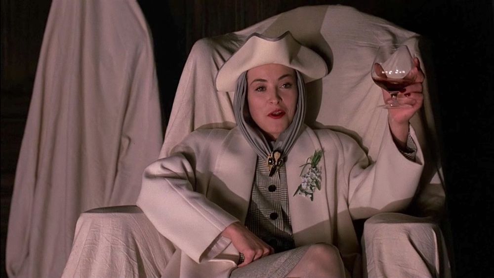 Amanda Donohoe, in a scene from “Lair of the White Worm,” wearing an ivory and grey ensemble topped with a white tricorn hat.