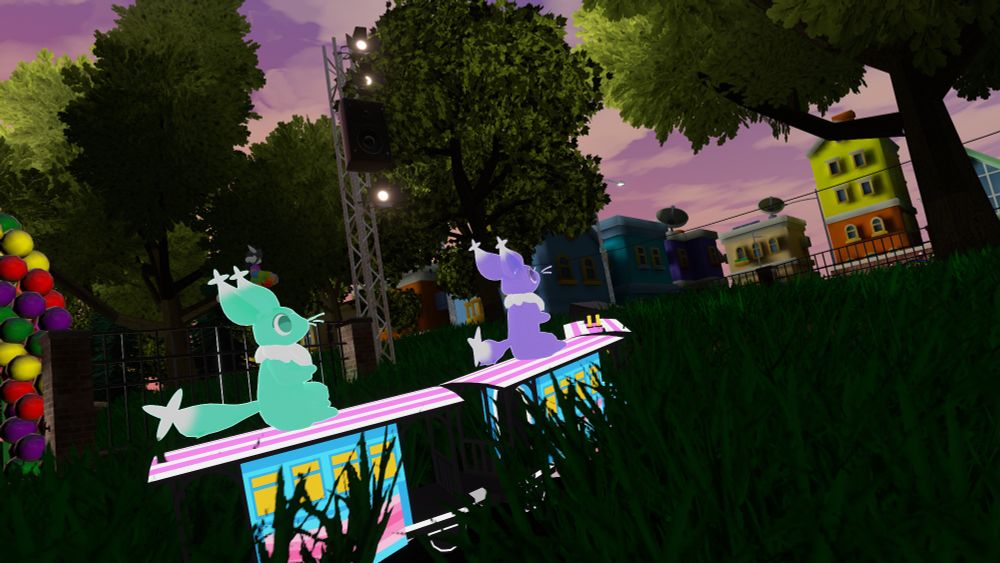 Dream Critters on a train in the grass at a park in Pride City, photo from behind on the right.