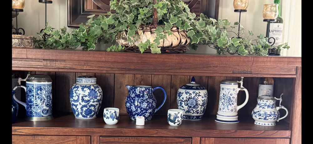 Blue & white porcelain beer, Steins,  ginger jars and pottery from Japan & Germany- displayed in a china cabinet 