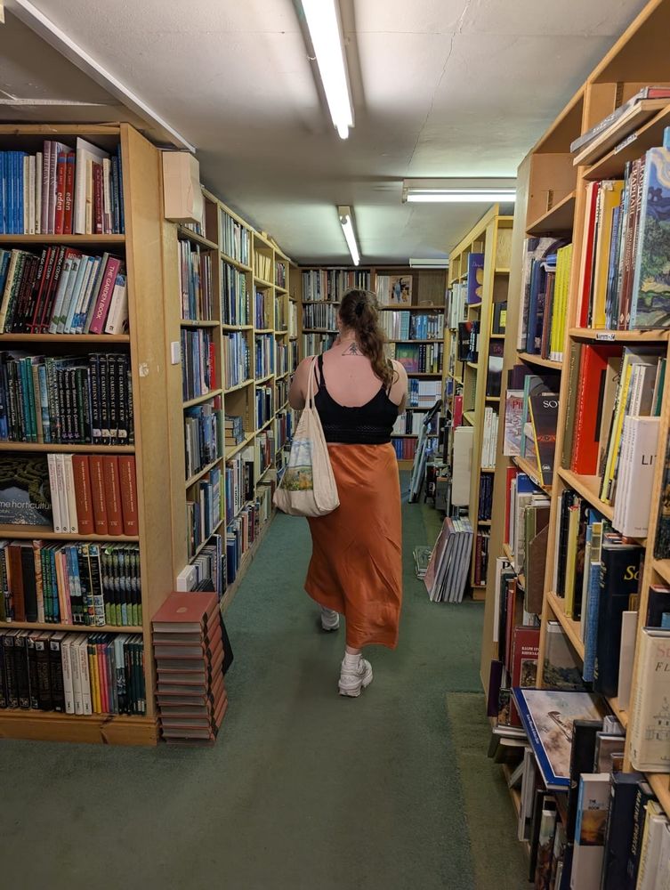 Woman walking through a bookshop