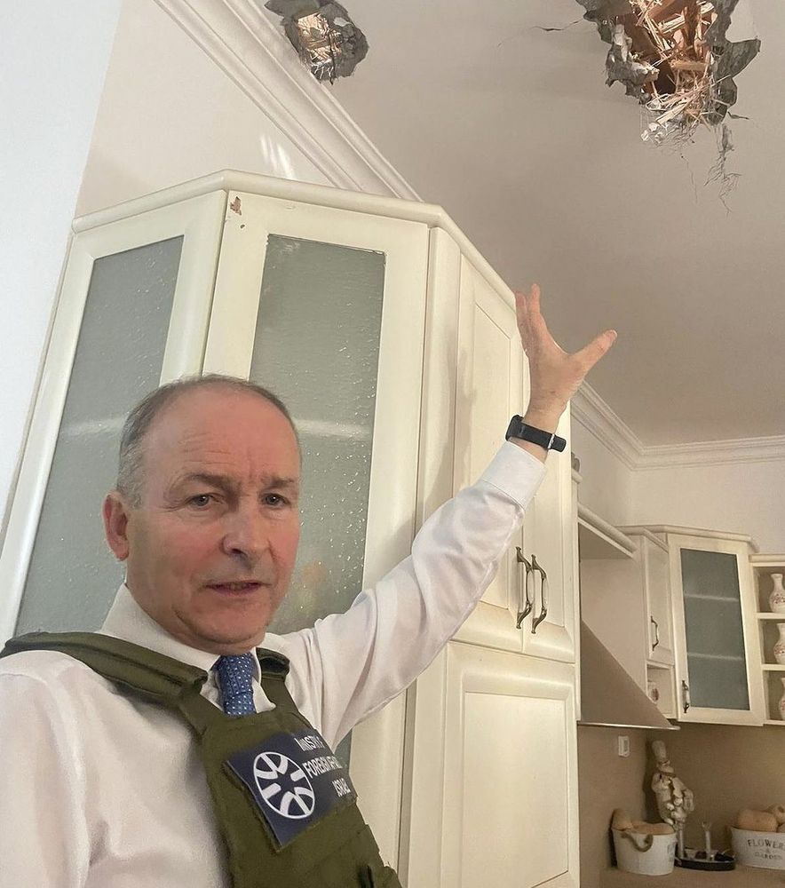 Micheal Martin pointing at a hole in the roof in Israel