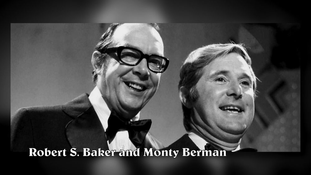 A black-and-white photo of two smiling, suited middle aged men, with a caption claiming that it's of film producer / director team Robert S. Baker and Monty Berman, is actually of British comedy duo Morecambe and Wise.