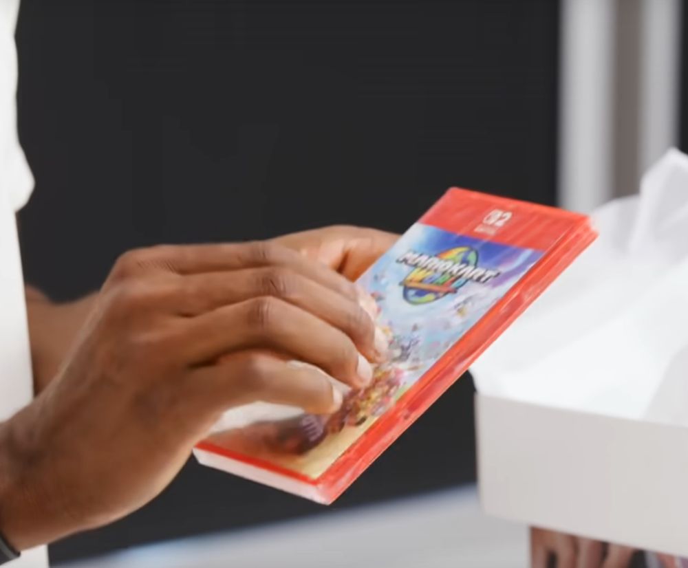 MKBHD holding a red Nintendo Switch 2 game case for Mario Kart World.