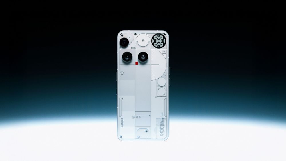 The back view of the Nothing Phone 3, showing internal components through a clear glass back panel, with a distinctive white dotted matrix display in the upper right corner