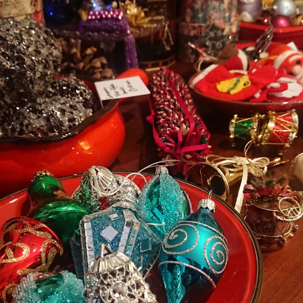 A selection of retro and vintage Christmas tree decorations, ornaments and baubles, including glittery turquoise glass, pinecones and a red felt Christmas stocking. 