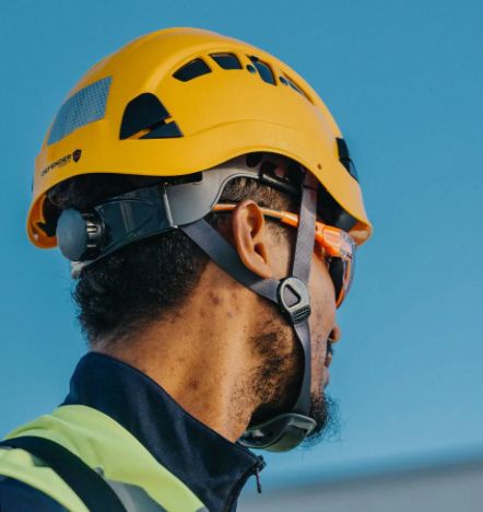 A worker wearing the latest in hard hats technology (chin strap, better fit).