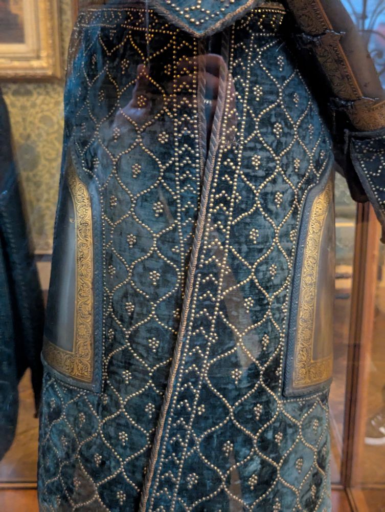 Side view of the skirt of the indian armor, showing of the sides of the skirt are open, but overlap. 
