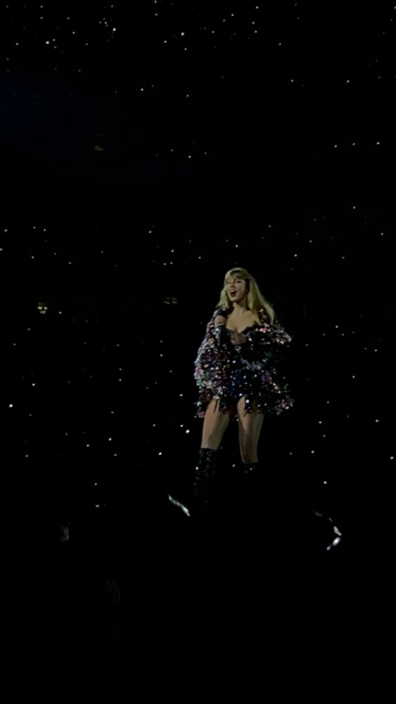 Taylor on the first night of the eras tour wearing the multicolored jacket.