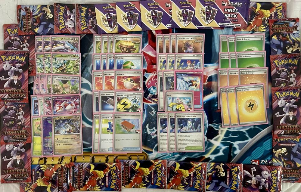 An image of the turbo Raging Bolt Ogerpon list with 18 Destined Rival packs and 5 Prize Packs surrounding the deck