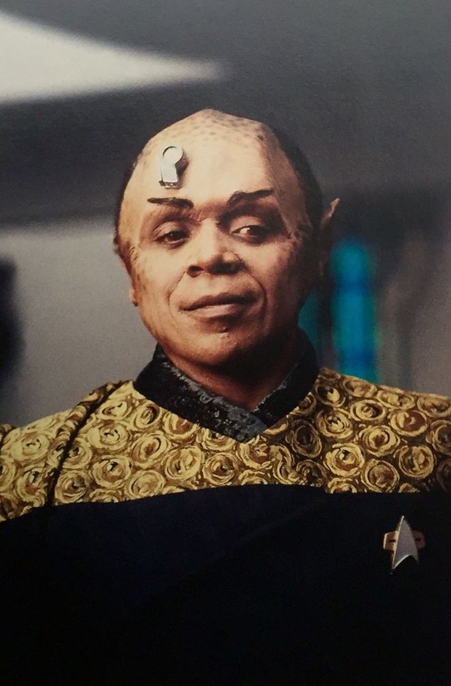 Actor Tom Wright in makeup as the transporter hybrid of STAR TREK: VOYAGER characters Tuvok and Neelix.

While the character has become iconic and controversial, Wright expressed concerns over his performance, claiming the production staff failed to guide him during his time on set. The producers themselves acknowledged Wright's difficulties, stating that the actor attempted to ad-lib dialogue, which was strictly forbidden in STAR TREK productions. Wright also claimed to struggle with TREK's notorious "technobabble" but received guidance from series regular Robert Duncan McNeill.