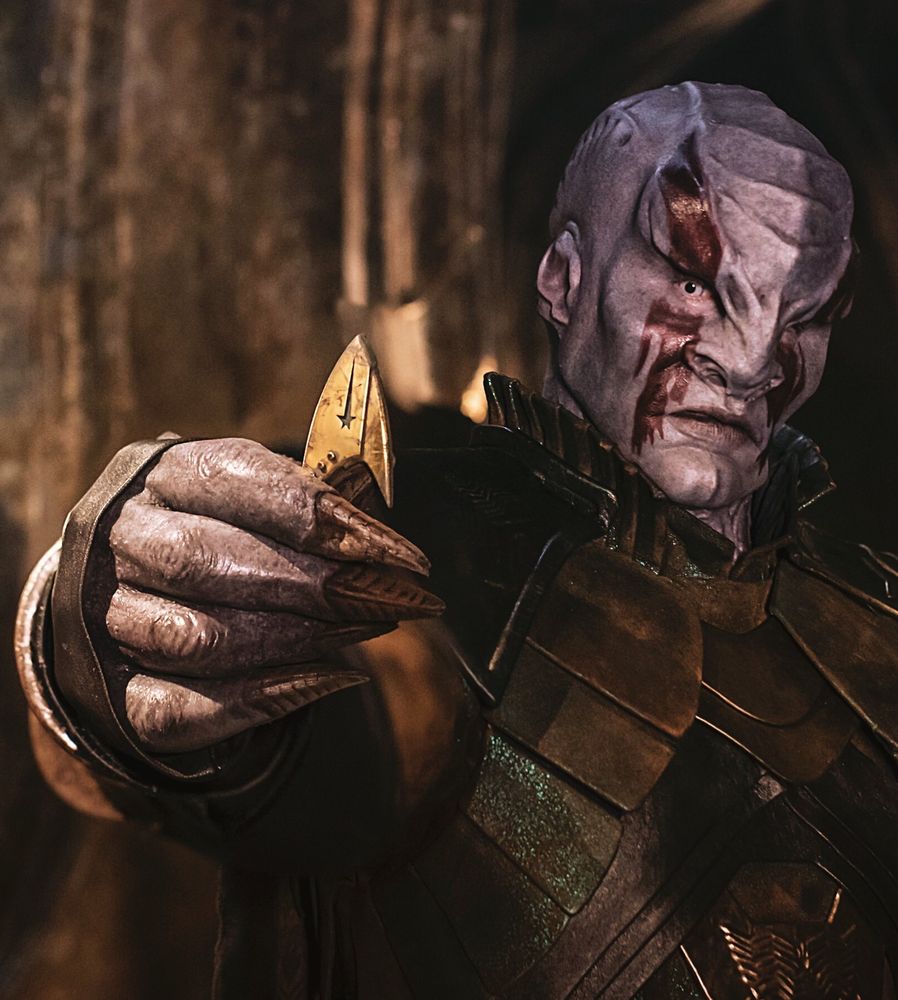 Kenneth Mitchell as Kol taunting Michael Burnham with the Starfleet badge of slain Captain Georgiou.

Played by the late Kenneth Mitchell, Kol was initially named Er'toom" (Shazam Latif was initially announced in the role). According to Mitchell, whatever the name of the character was going to be, he had little information about the role he was auditioning for: "When I auditioned, I didn't know I was auditioning to be a Klingon."