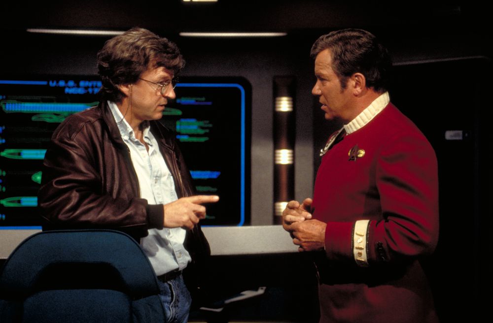 Director David Carson and William Shatner on the Enterprise-B bridge set.

Having directed notable STAR TREK entries like "Yesterday's Enterprise" and DS9's pilot episode, "Emissary", Carson had difficulty adapting to working on the big screen, according to Rick Berman: "There were a lot of problems with David directing GENERATIONS because he went from being a television director to being a movie director in personality and approach very quickly. He fell behind schedule very quickly. ...And the studio started going ape-shit. They got very upset at him. I remember there were people flying into Las Vegas where we were shooting out in the desert and insisting on him speeding things up because we were falling behind."