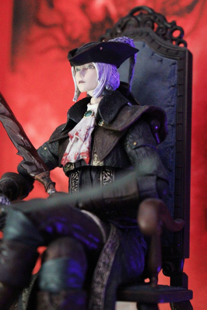 Macro shot of Lady Maria Fogma figurine. She's sitting on the chair holding both swords 
