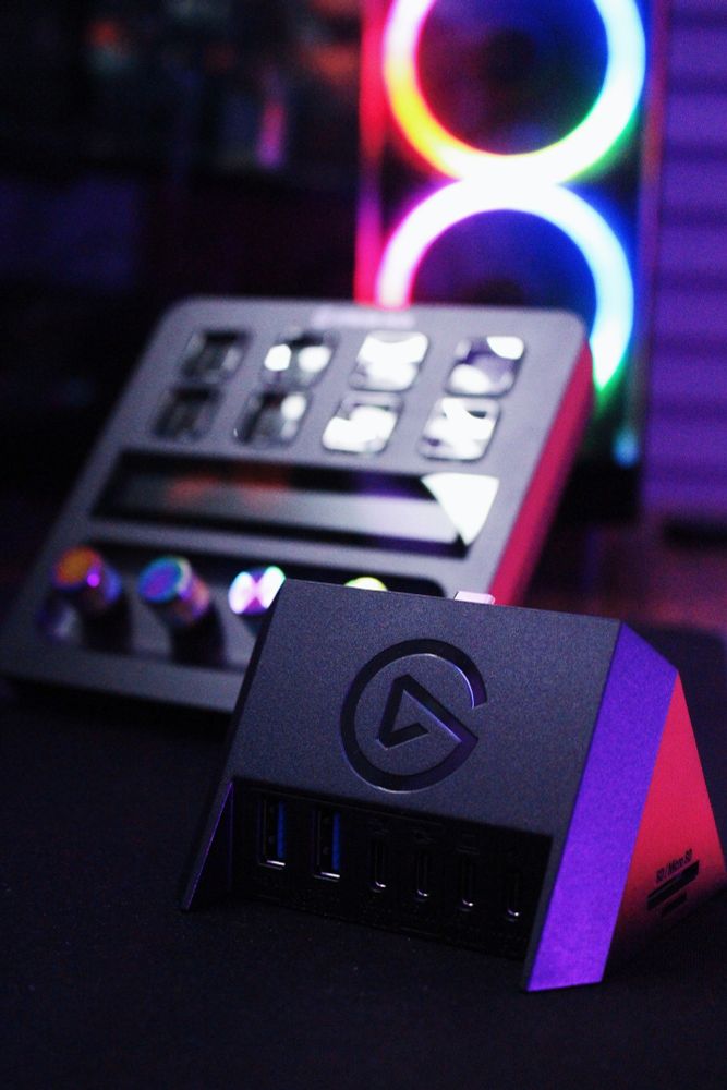 Close up on USB Hub with Stream Deck + and pc with RGB fans in background 