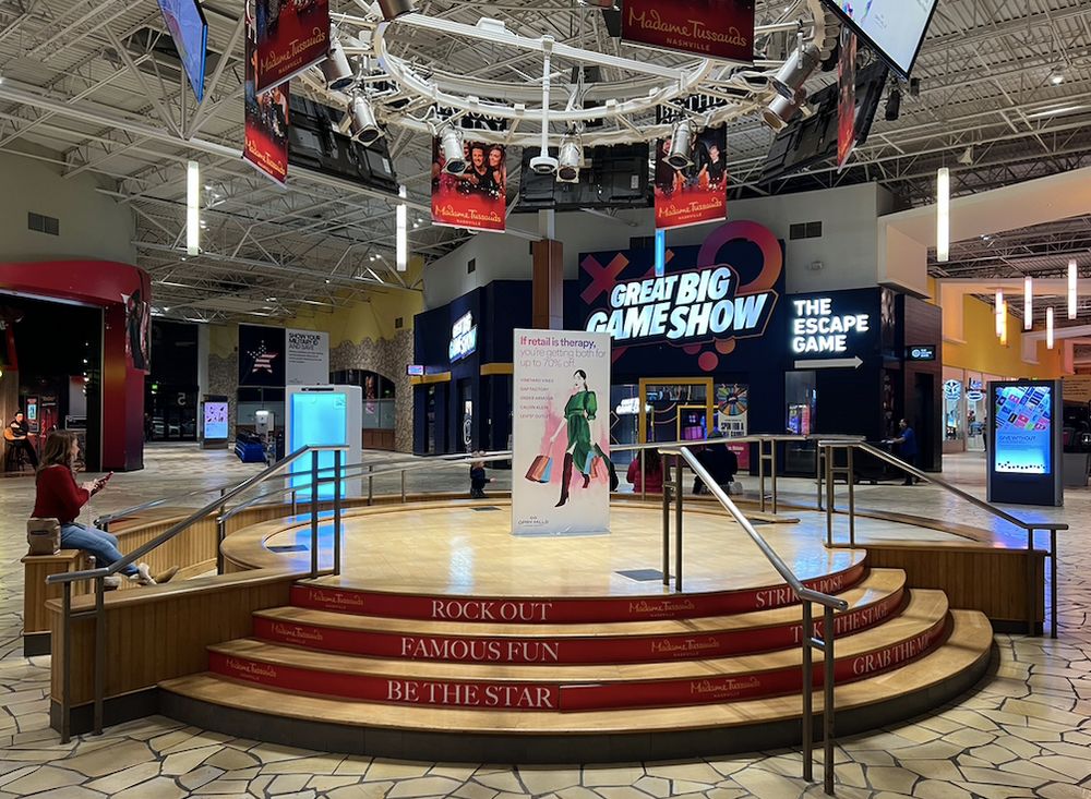 The "Entertainment Stage" in the atrium at the Opry Mills Mall. The text on the stairs leading up to the stage says "Rock out, Famous Fun, Be The Star."