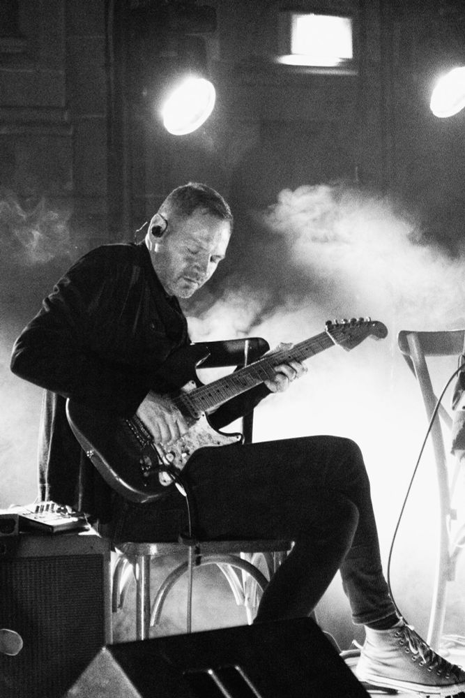 A black and white image from a concert of the band Constant Follower