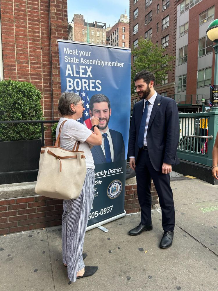 Assemblymember Alex Bores greeting constituents during the morning commute at subway stops.