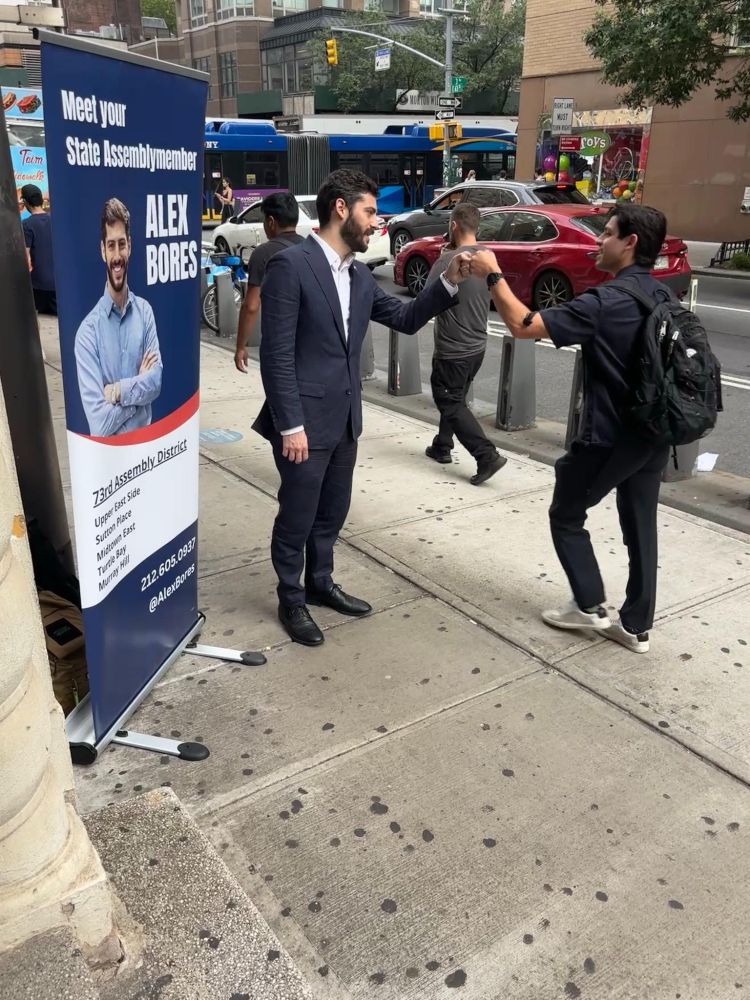 Assemblymember Alex Bores greeting constituents during the morning commute at subway stops.