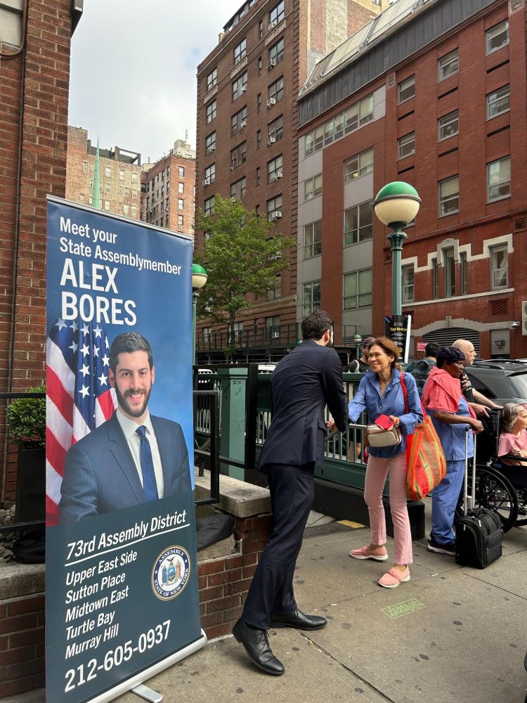 Assemblymember Alex Bores greeting constituents during the morning commute at subway stops.