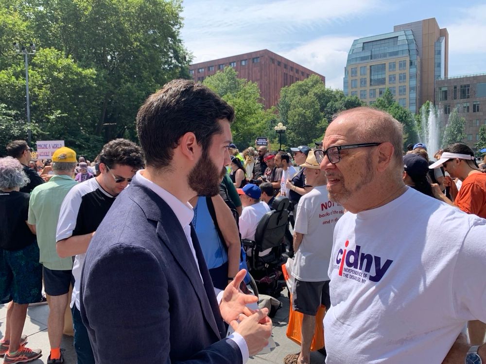 Assemblymember Alex Bores talks with advocates at an ADA 35th anniversary protest.