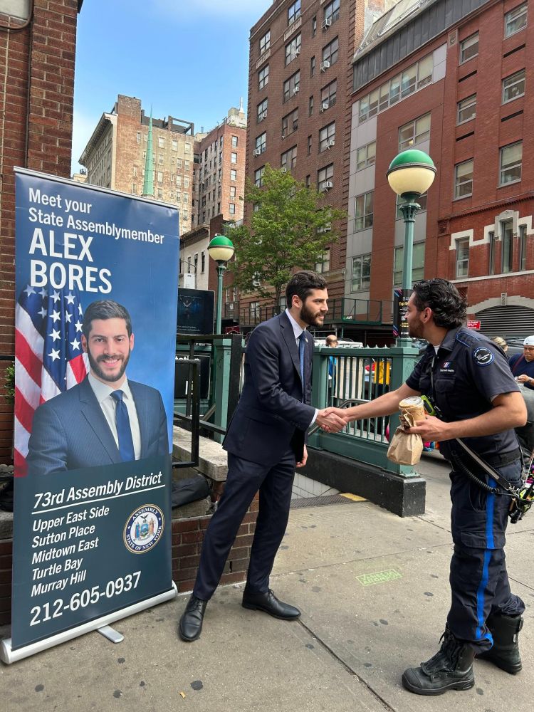Assemblymember Alex Bores greeting constituents during the morning commute at subway stops.