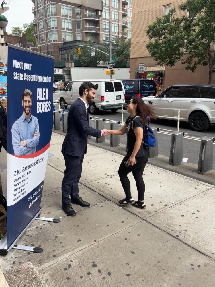 Assemblymember Alex Bores greeting constituents during the morning commute at subway stops.
