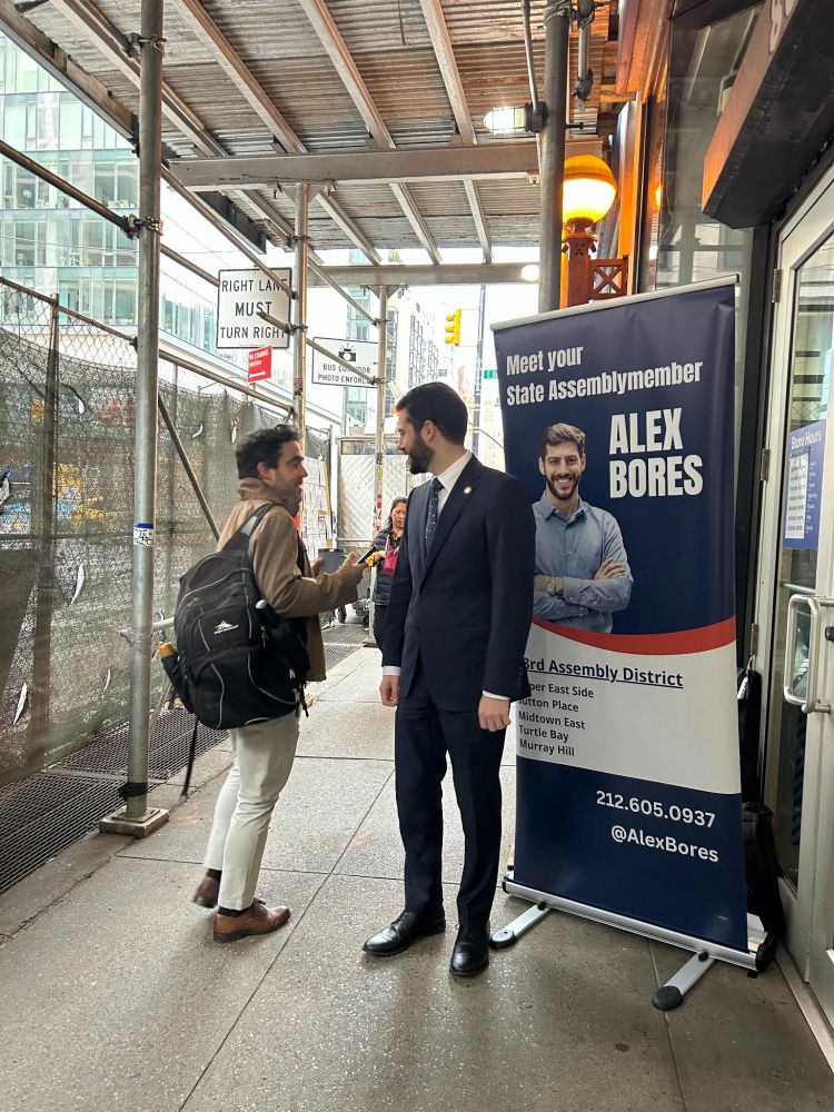Assemblymember Alex Bores greeting constituents during the morning commute at subway stops.