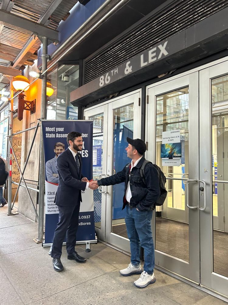 Assemblymember Alex Bores greeting constituents during the morning commute at subway stops.