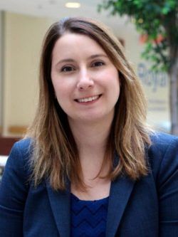 Photo of Professor Kelly Babchishin, smiling and wearing a blue blazer. She has brown hair.