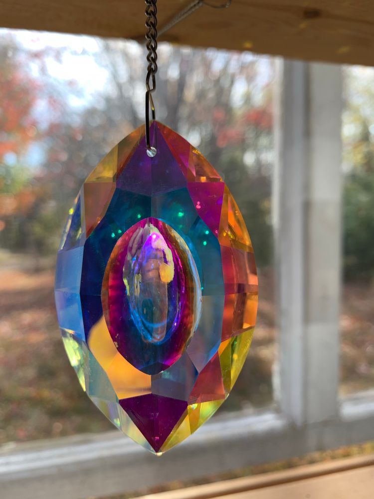 Crystal in window with prisms of light