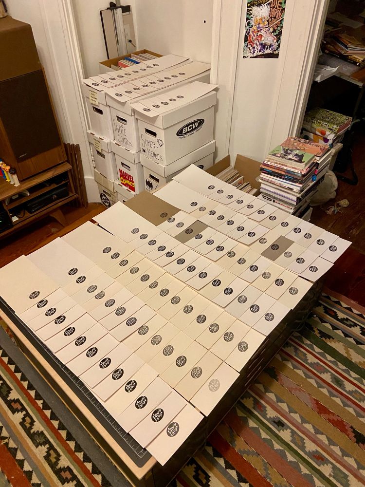 Backing boards lined up in a clean grid that have been stamped with the Stoop Shop logo