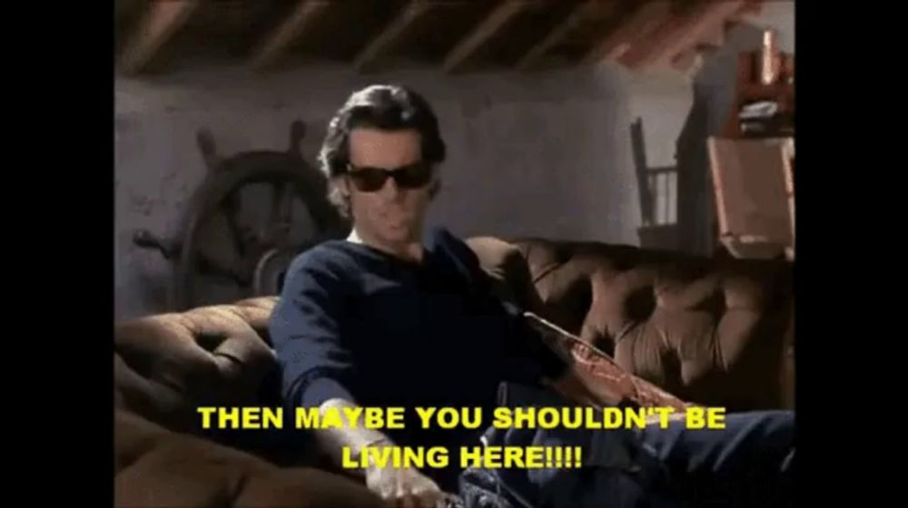 a man wearing sunglasses sits on a couch and says then maybe you shouldn 't be living here !!!