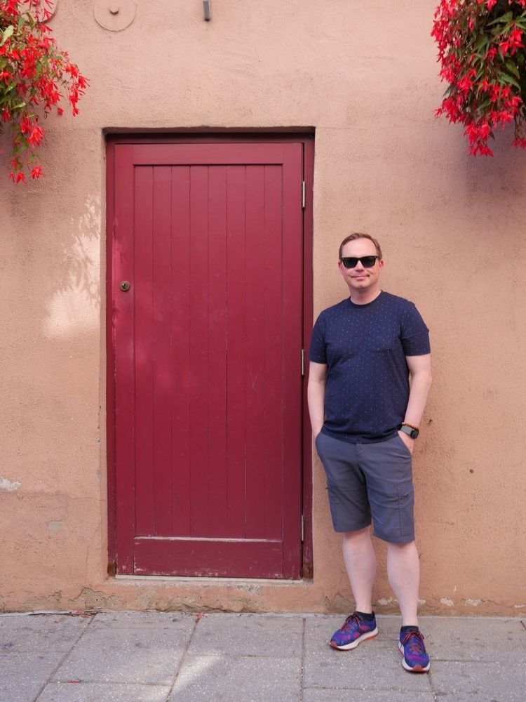 Chad stands beside a Red Door in Lower Quebec