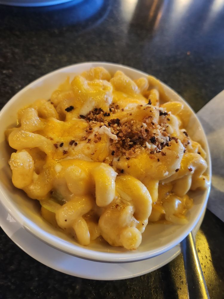 A bowl of homestyle mac 'n cheese topped with bread crumbs. 