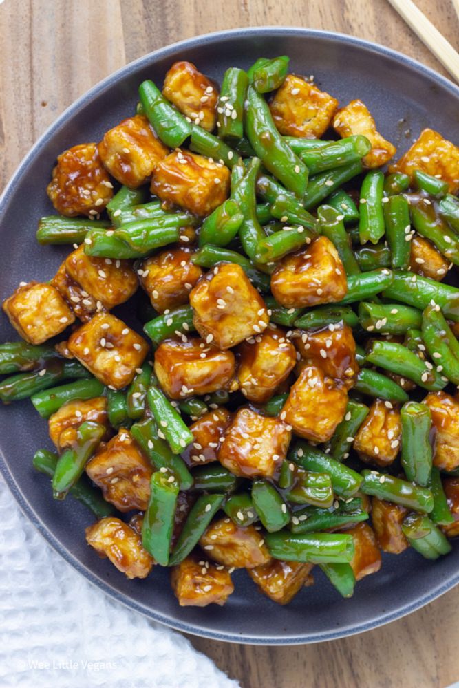 Close up of Hoisin Tofu and Green Beans on a gray plate. 