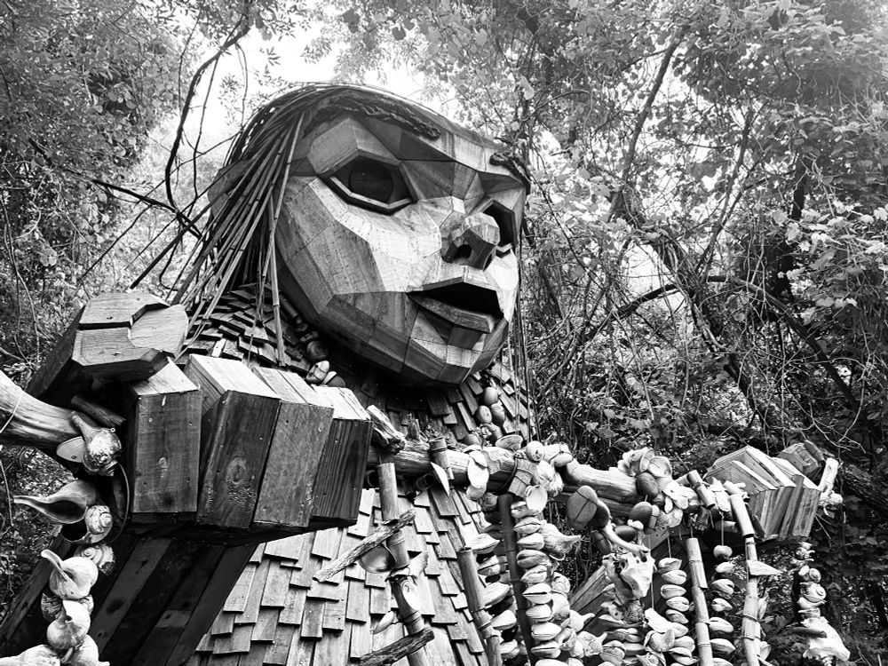 A black and white photo of Greta Granit, a troll sculpture made by Thomas Dambo in Rhode Island.