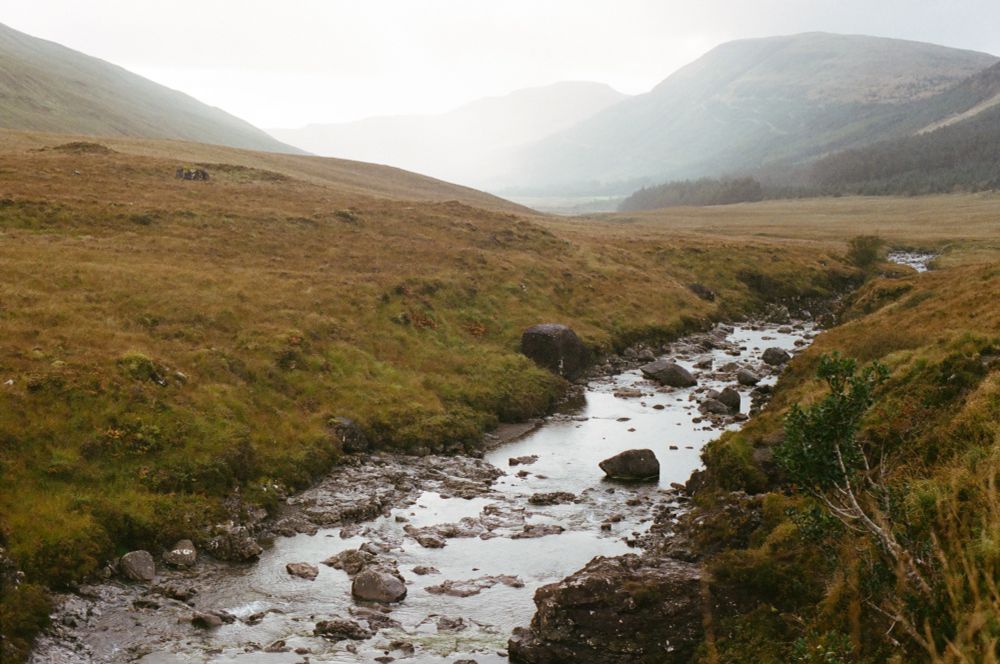 Water from the Fairy Pools flow through a meadow in Scotland.