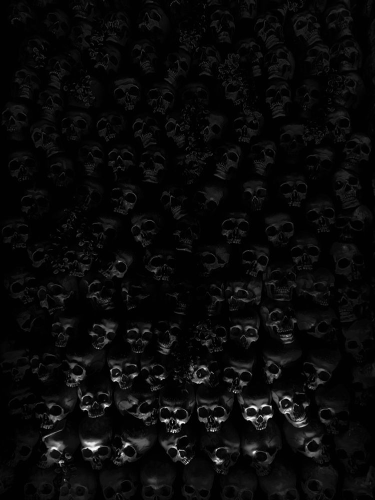 A black and white photo of a wall of skulls.