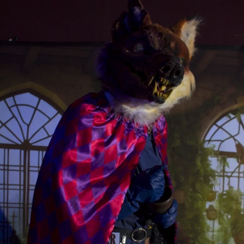 A close up of Slagar crushing herbs with an ominous shadow falling across his disfigured face.