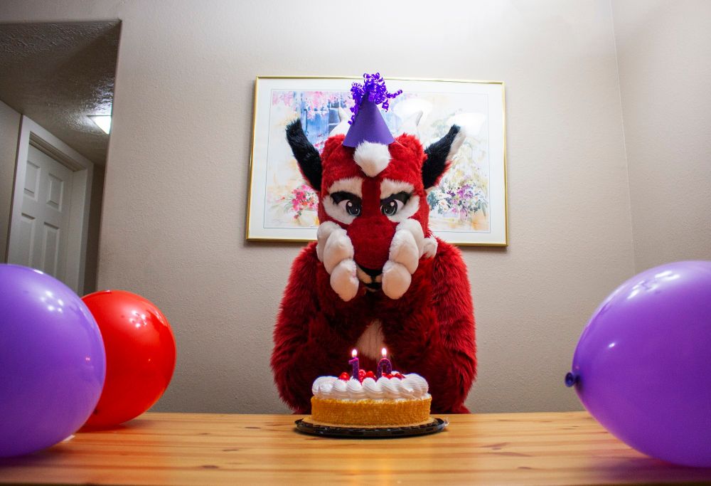 This puma dragon doesn't even know what to do with this cake with "10" candles sitting in front of them. Well, at least they've got balloons near by. They know what to do with those.