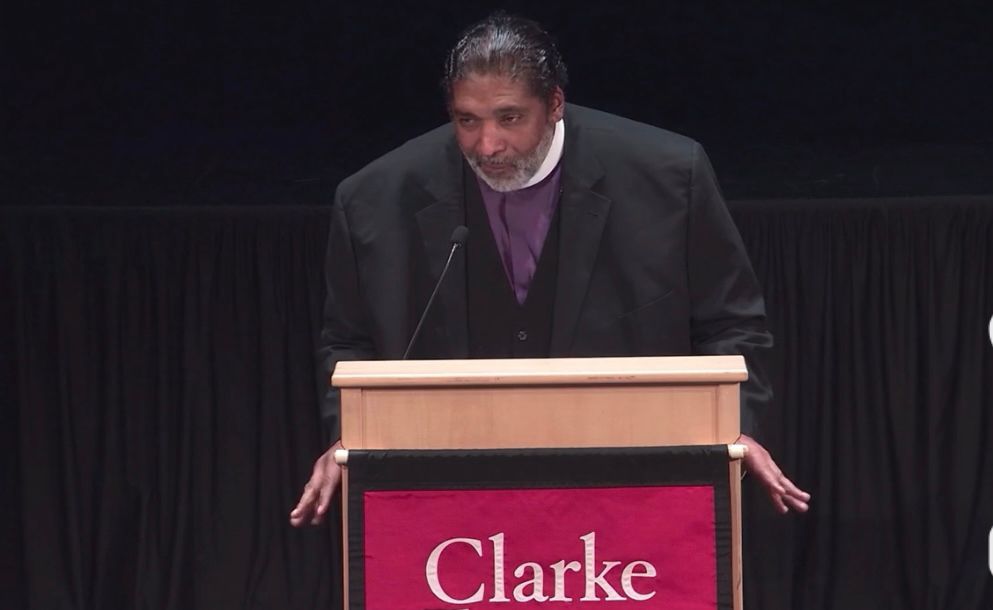 live closeup screenshot of Bishop at podium