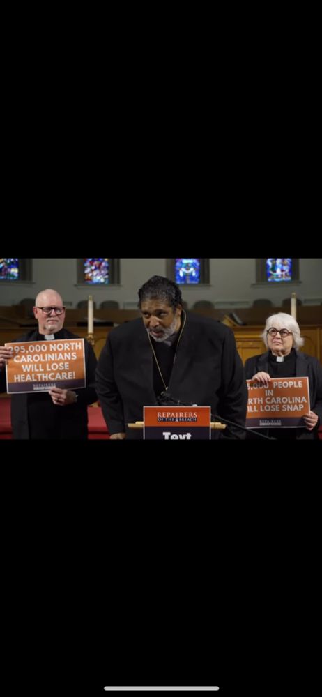 Live screenshot of presser .... Bishop is speaking .... standing at podium, flanked by two clergy