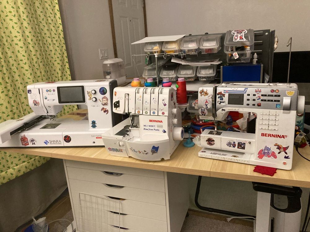 Embroidery machine, Serger machine & Sewing machine lined up on a desk