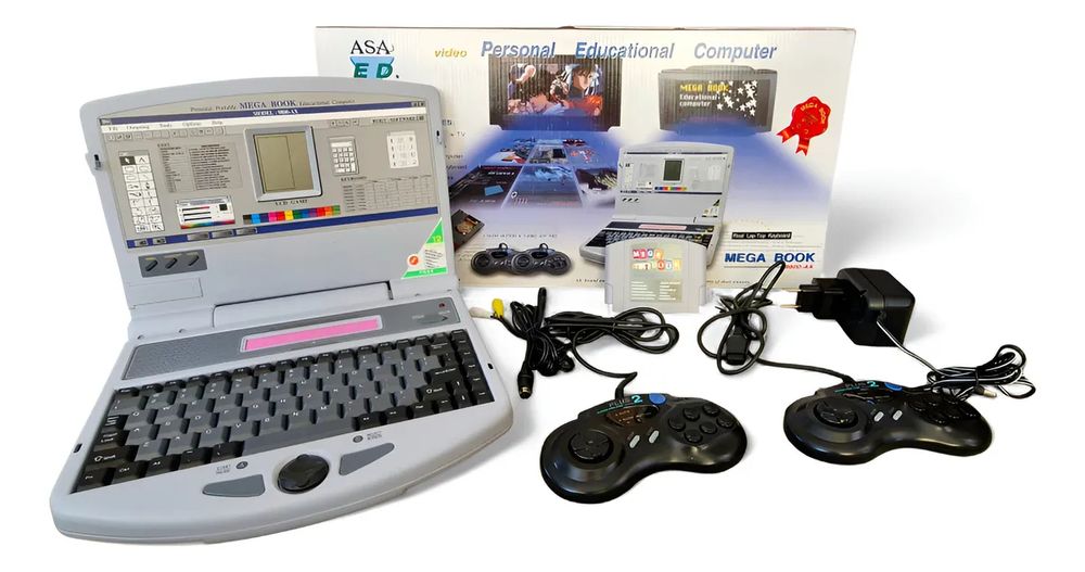 A Mega Book 9800-AX famiclone console beside its own box and accessories (cables, Genesis-shaped controllers, a bootleg Famicom multicart). The console is shaped like a small laptop, with a keyboard on the bottom, under the Famicom cartridge slot, and detailed artwork on the top lid making it look like a screen with an early Windows-style interface open.