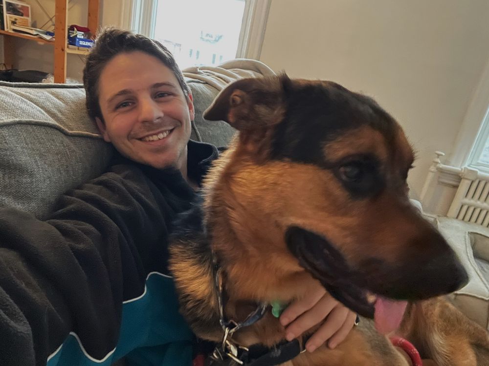 Picture of guy with his large Shepherd-mix, a dog named Dr. Luka.