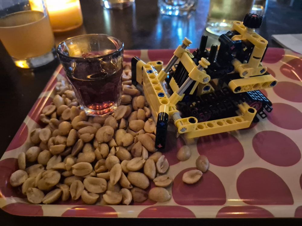 LEGO Bulldozer neatly pushing a pile of peanuts with half a fernet on!